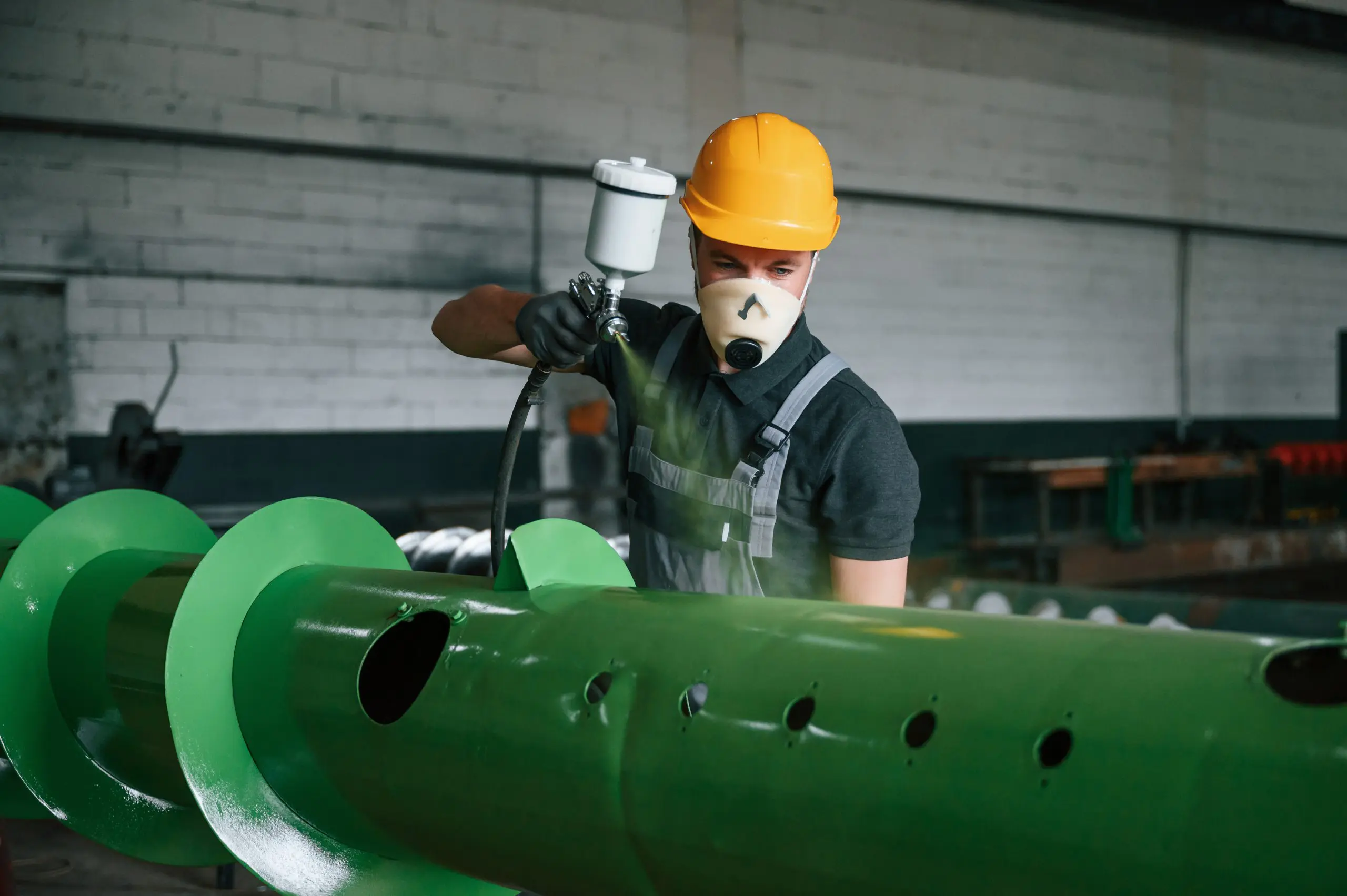 Image of a pipe join waiting to be powder coated with masking to prevent the openings being powder coated.