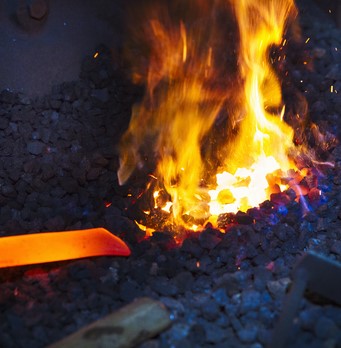A length of red hot metal in a furnace.