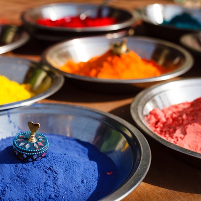 India symbol. Colored colorful powder kumkum in bowls on Indian bazaar for Holi and other festivals celebration